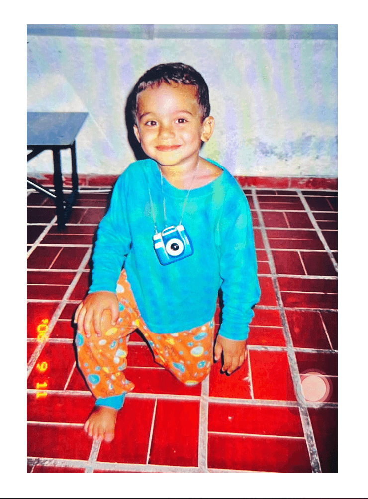 Luis as a kid with a camera